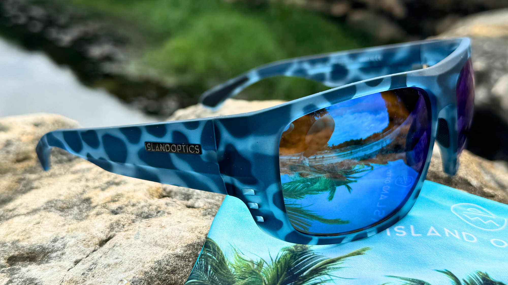 Polarized sunglasses with reflective lenses on a wooden surface, highlighting the glare reduction feature essential for bright outdoor conditions.