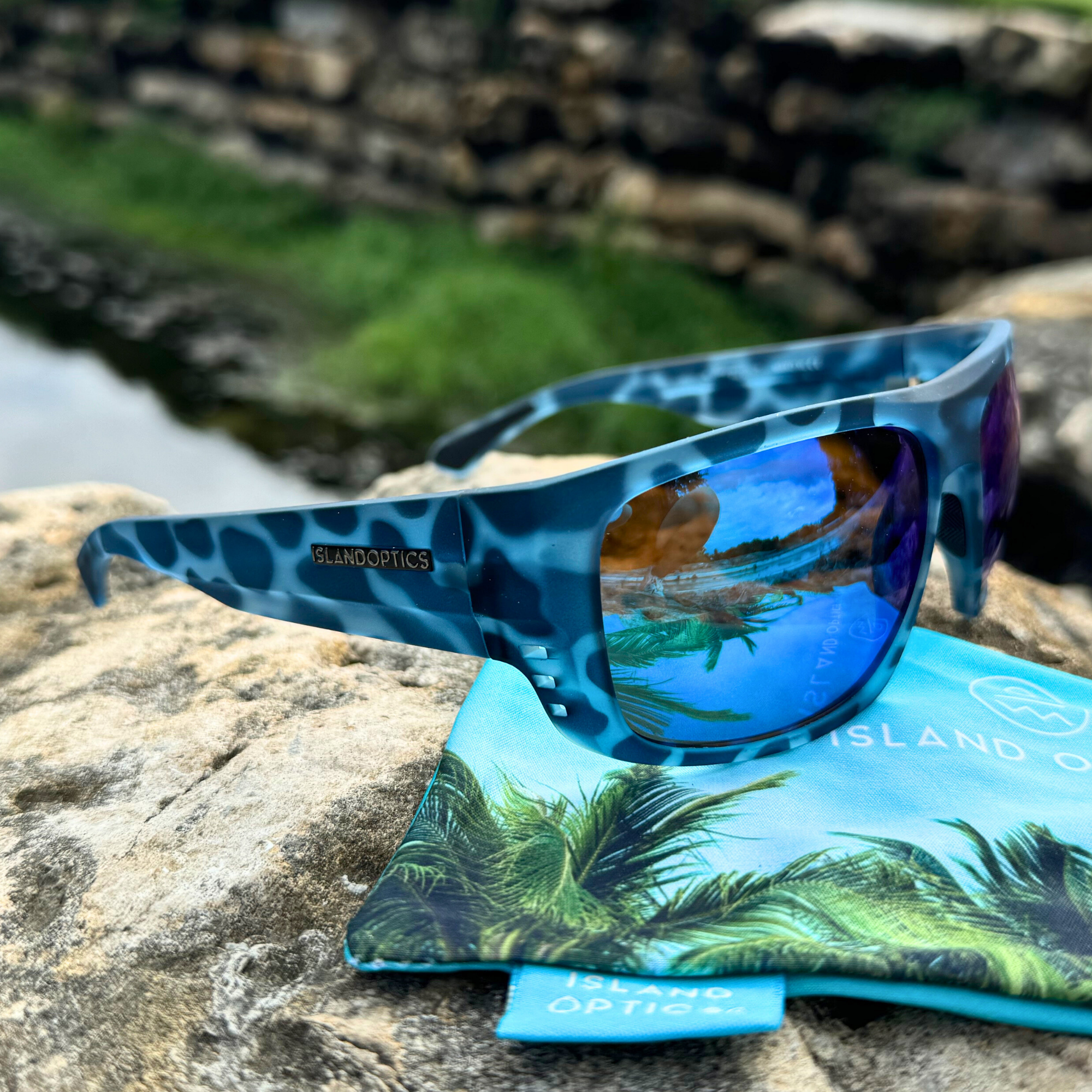 Polarized sunglasses with reflective lenses on a wooden surface, highlighting the glare reduction feature essential for bright outdoor conditions.