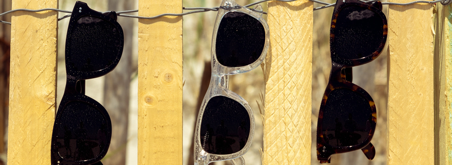Polarized sunglasses with reflective lenses on a wooden surface, highlighting the glare reduction feature essential for bright outdoor conditions.